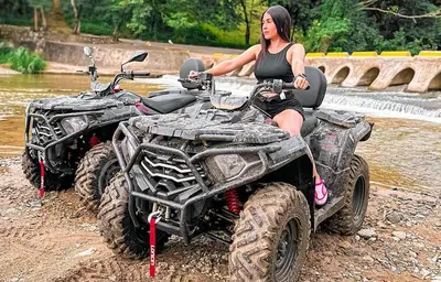 a woman sitting on a four wheeler in the mud at Casita de Campo VIVE in Pedro Brand