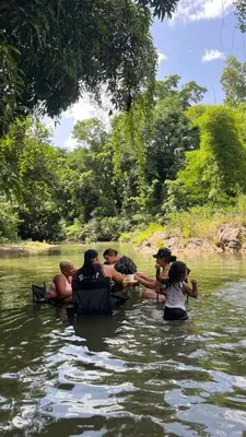 a group of people in the water on a river at Casita de Campo VIVE in Pedro Brand