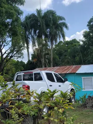 a white truck parked in front of a house at Casita de Campo VIVE in Pedro Brand