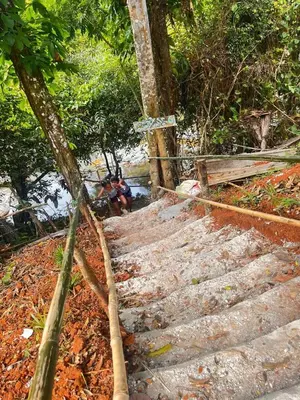 a group of stairs with a person sitting on a bench at Casita de Campo VIVE in Pedro Brand