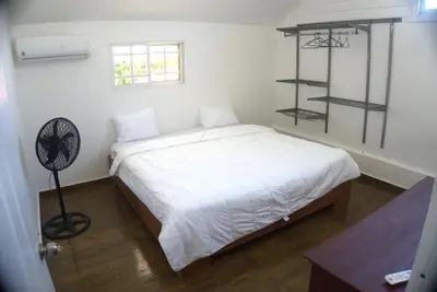 a bedroom with a white bed and a fan at Villa Emili in Las Terrenas