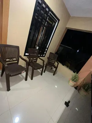 a living room with two chairs and a fireplace at Rincón Paraíso Cheché in Dajabón