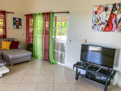 a living room with a flat screen tv and a couch at Villa 17M in Sosúa