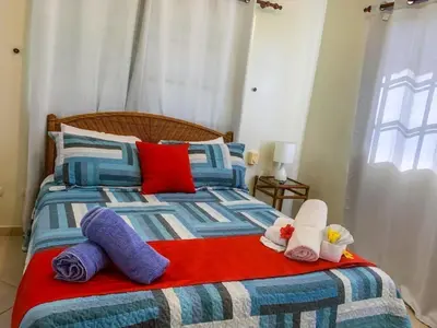 a bed with two stuffed animals sitting on it at Villa 17M in Sosúa