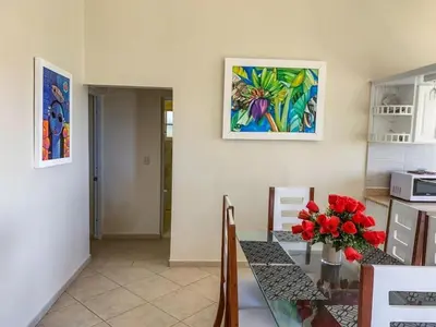 a kitchen with a table and a painting on the wall at Villa 17M in Sosúa
