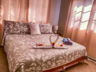 a bed with two dolls on top of it at Villa 17M in Sosúa