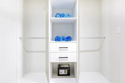 a closet with white shelves and blue bowls at Quiet 1-Bedroom Apartment with Pool View in Gated Bávaro Residence in Punta Cana