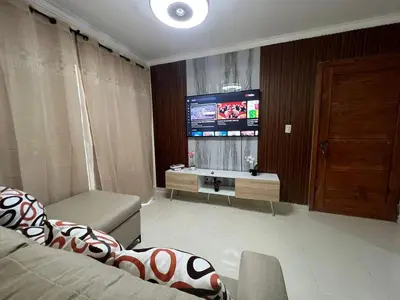 a living room with a couch and a television at Los manglares in La Cana