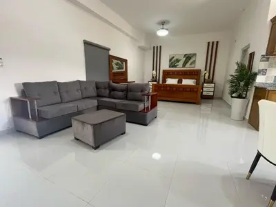 a living room with a couch and a table at Hotel Altos de la Montaña in Colonia Japonesa