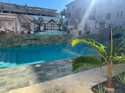 a large swimming pool in front of a building at Apartment bayahibe in Bayahibe