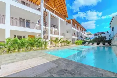a swimming pool in front of a building at Apartment bayahibe in Bayahibe