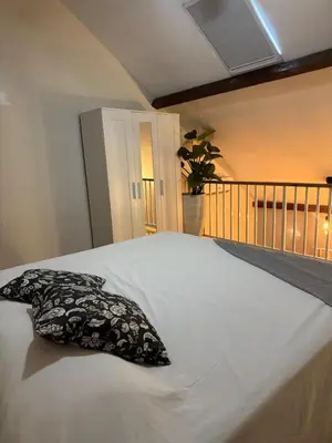 a bed with a black and white pillow on it at Apartment bayahibe in Bayahibe