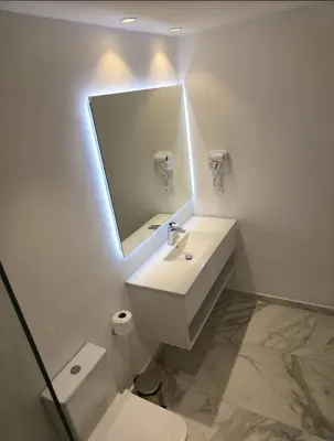 a white bathroom with a sink and a mirror at Exclusive 2BR Apartment Punta Cana in Punta Cana