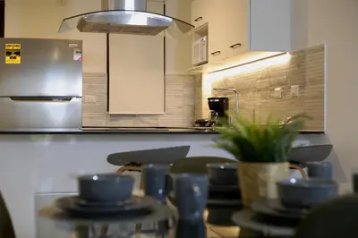a kitchen with a table with blue cups on it at Exclusive 2BR Apartment Punta Cana in Punta Cana
