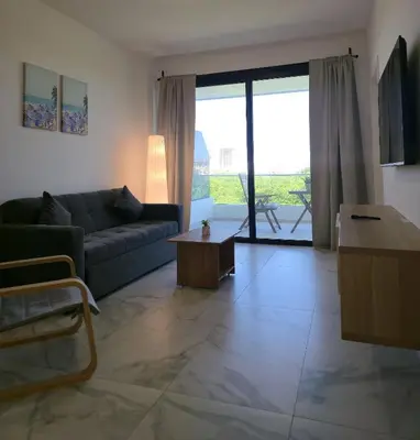a living room with a couch and a table at Exclusive 2BR Apartment Punta Cana in Punta Cana