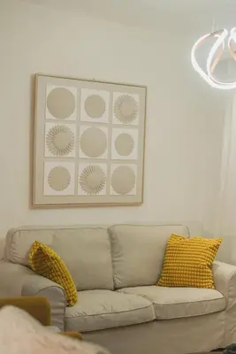 a living room with a couch and a picture on the wall at San Isidro Urban Suite in Juan López