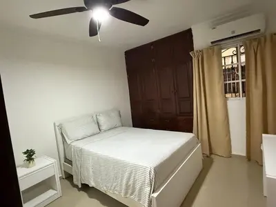 a bedroom with a bed and a ceiling fan at Getaway paradise in Los Mameyes