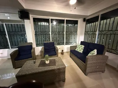 a living room with couches and a table at Getaway paradise in Los Mameyes