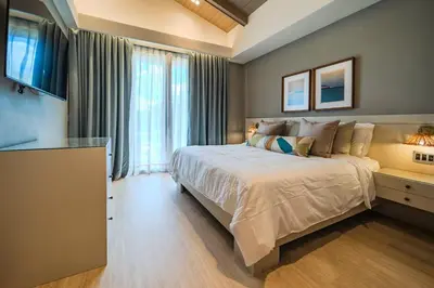 a bedroom with a large bed and a large window at Luxury Guesthouse Villa with Golf Cart - Casa de Campo in La Romana