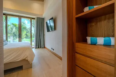a bedroom with a bed and a large window at Luxury Guesthouse Villa with Golf Cart - Casa de Campo in La Romana