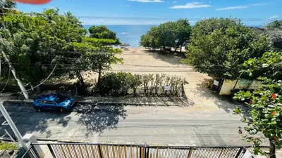 a car parked in a parking lot next to the ocean at oceanfront apartment in La Puntica de Juan Dolio