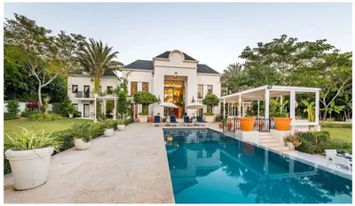 a house with a swimming pool in front of it at Luxury Awaits at Casa de Campo A Stunning Five-Bedroom Retreat in La Romana