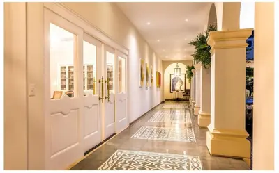a hallway with white doors and a tile floor at Luxury Awaits at Casa de Campo A Stunning Five-Bedroom Retreat in La Romana