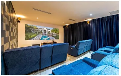 a living room with blue couches and a table at Luxury Awaits at Casa de Campo A Stunning Five-Bedroom Retreat in La Romana