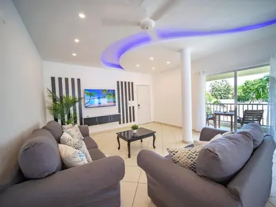 a living room with couches and a blue ceiling at Plaza Achim 2BR APT heart of nightlife area in Sosúa