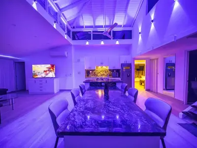 a large meeting room with a large table and chairs at Luxury 3BR Penthouse 300m from beach in Sosúa