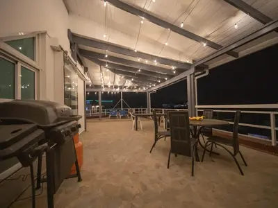 a room with a grill and tables and chairs at Luxury 3BR Penthouse 300m from beach in Sosúa