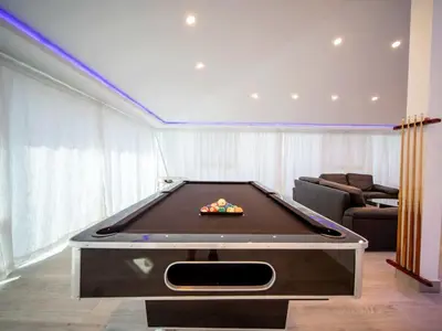 a living room with a pool table in a room at Luxury 3BR Penthouse 300m from beach in Sosúa