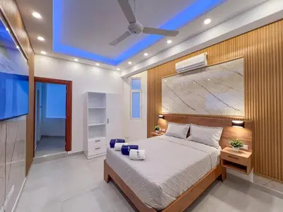 a bedroom with a large bed with a blue ceiling at Plaza Achim 7 Luxury Apt 250m from Sosua Beach in Sosúa