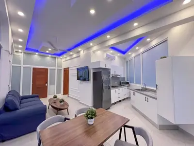 a living room with a table and a blue ceiling at Plaza Achim 7 Luxury Apt 250m from Sosua Beach in Sosúa