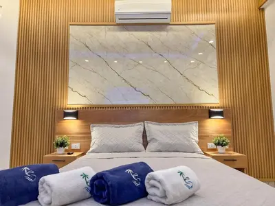 a bedroom with a large bed with towels on it at Plaza Achim 7 Luxury Apt 250m from Sosua Beach in Sosúa