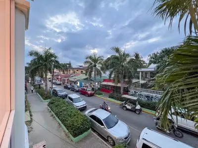 a street with cars parked on the side of the road at Plaza Achim 7 Luxury Apt 250m from Sosua Beach in Sosúa
