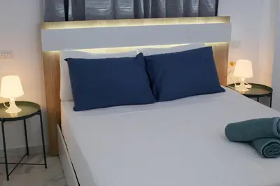 a bedroom with a bed with blue pillows and two lamps at Spacious 3BR Residence in Punta Cana by Infinity Homes in Punta Cana