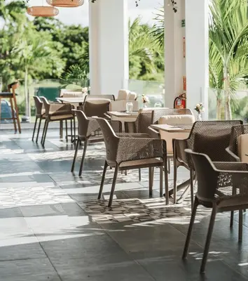a row of tables and chairs in a restaurant at Spacious 3BR Residence in Punta Cana by Infinity Homes in Punta Cana