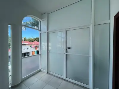 an empty room with glass doors and a window at Plaza Achim 6B, Modern APT 250m from Sosua beach! in Sosúa
