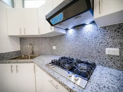 a kitchen with a stove and a counter top at Plaza Achim 6A, Modern APT 250m from Sosua beach! in Sosúa
