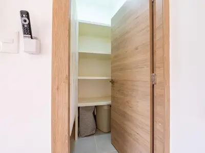 a room with a closet with a wooden door at Rooftop Penthouse Jacuzzi, 2 Pools Playa Popy 500m in Las Terrenas