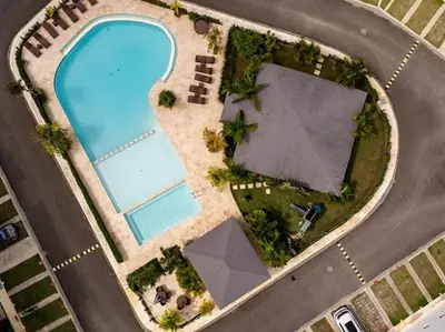 an overhead view of a swimming pool next to a road at Rooftop Penthouse Jacuzzi, 2 Pools Playa Popy 500m in Las Terrenas