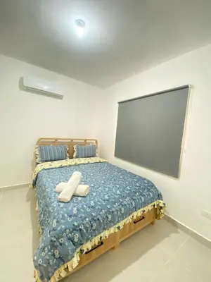 a bedroom with a bed with two white towels on it at 3 bedroom apartment in Armonía Las Terrenas in Las Terrenas