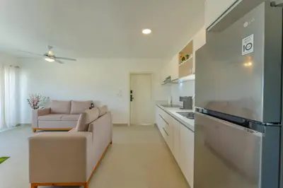 a kitchen and living room with a couch and a refrigerator at Prime Apartment with Fast Internet & Washer in SOV in Sosúa