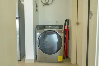 a washing machine and a television in a room at Prime Apartment with Fast Internet & Washer in SOV in Sosúa