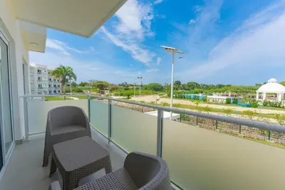 a balcony with chairs and a view of the water at Prime Apartment with Fast Internet & Washer in SOV in Sosúa