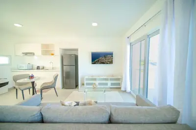 a living room with a couch and a dog laying on the floor at Work & Relax Studio Pools & Fast Wi-Fi in SOV in Sosúa