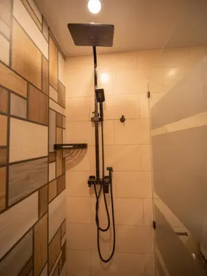 a shower with a hose in a bathroom at Garden Condos 5 - Ultra Modern Apartment in Sosua in Sosúa