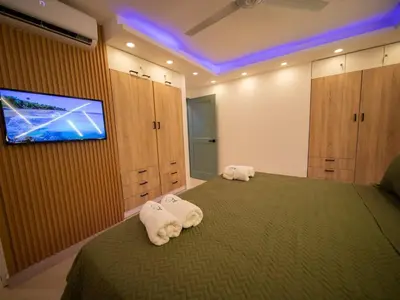 a bedroom with a bed with towels on it at Garden Condos 5 - Ultra Modern Apartment in Sosua in Sosúa