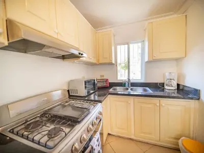 a kitchen with a stove top oven next to a sink at Garden Condos 9 Affordable APT in Sosua downtown in Sosúa